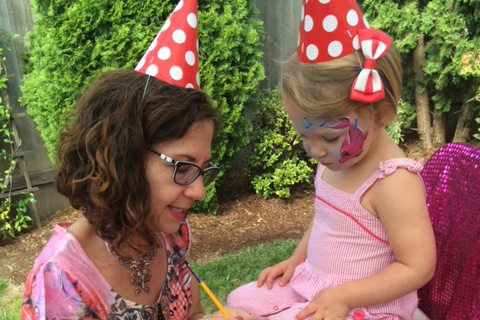 short term nanny with birthday hat on caring for a young girl