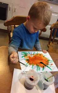 Child making art on paper